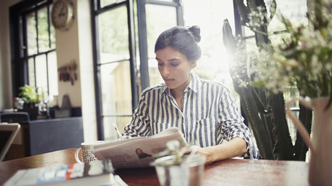 woman reading a newspaper