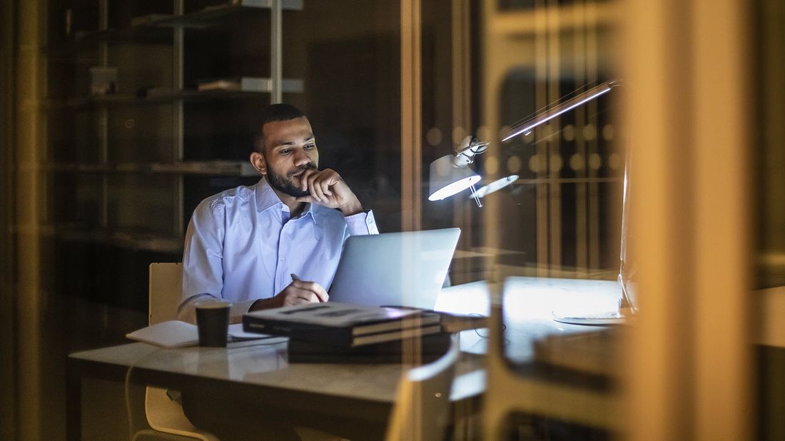 Man at desk reading Northwestern Mutual Market Commentary