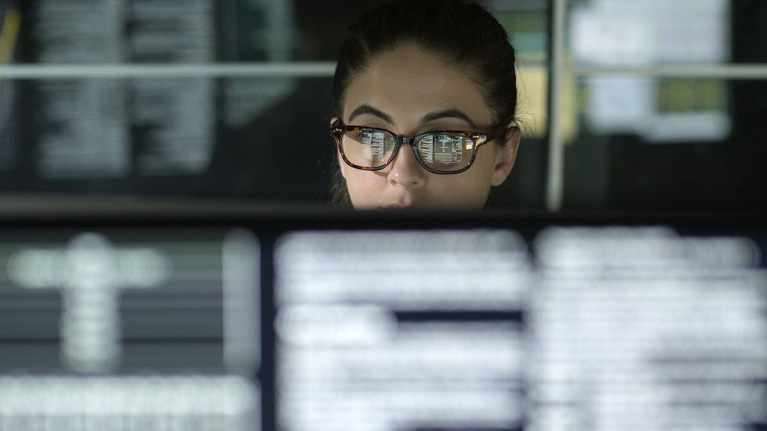 Woman looking at computer screens.