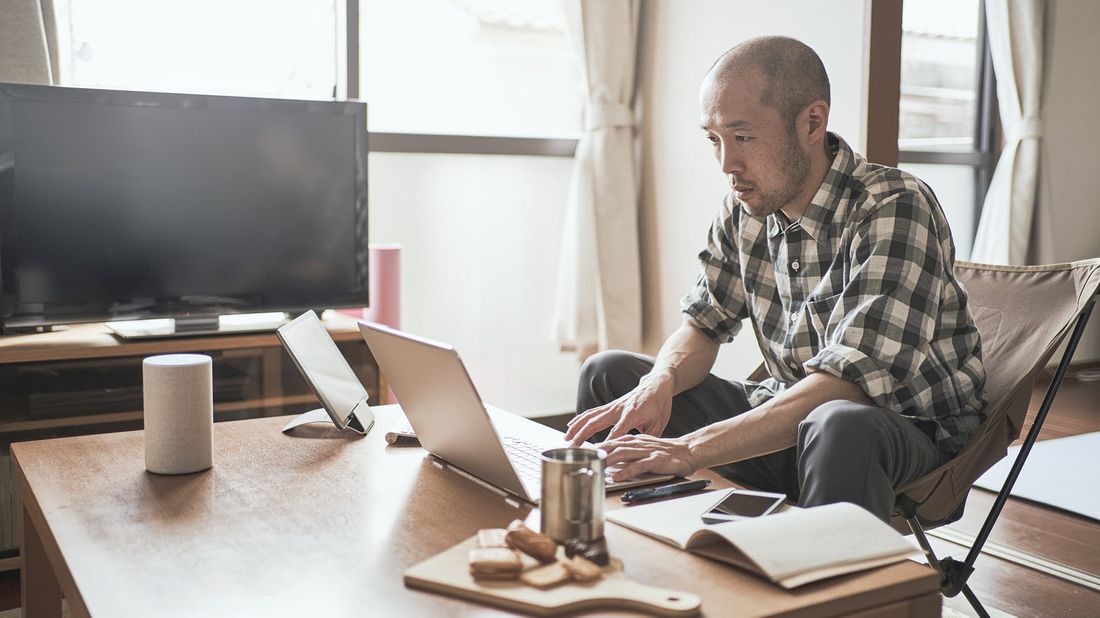 Man working at home and reading Northwestern Mutual Market Commentary 