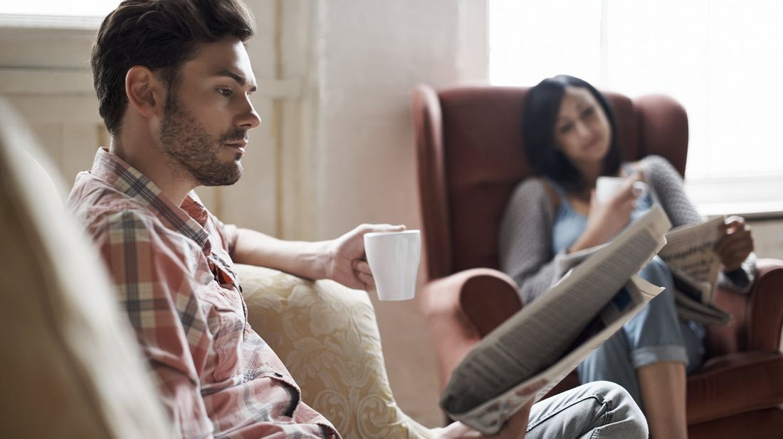 Husband and wife reading conflicting market news.