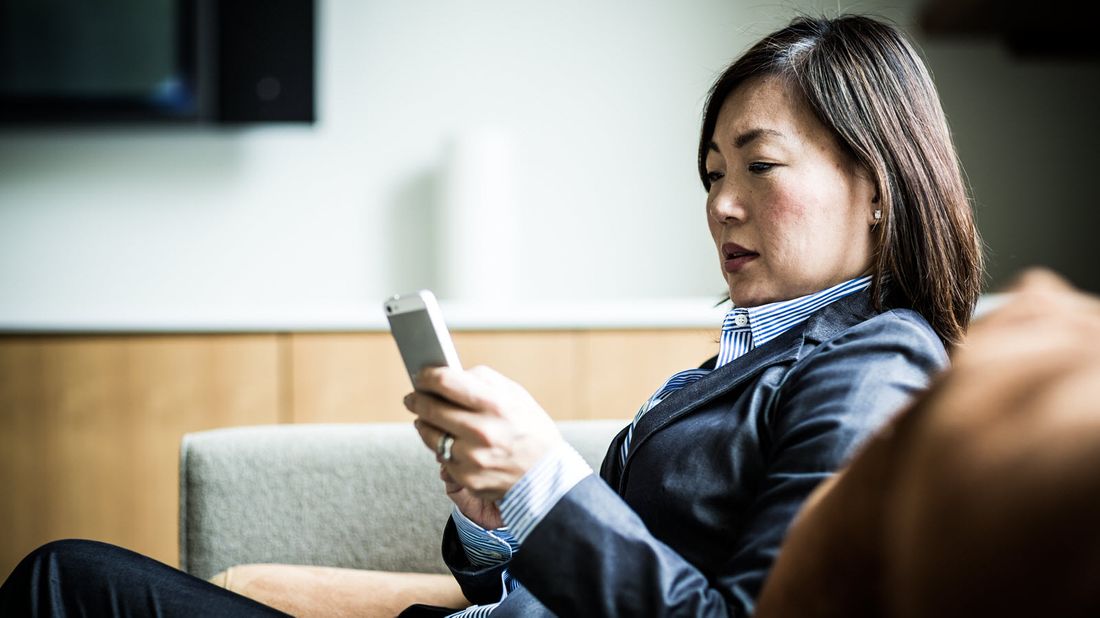 Woman reading Northwestern Mutual Market Commentary.