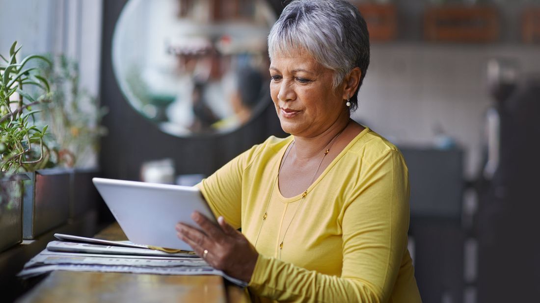 Woman reading Northwestern Mutual Market Commentary.