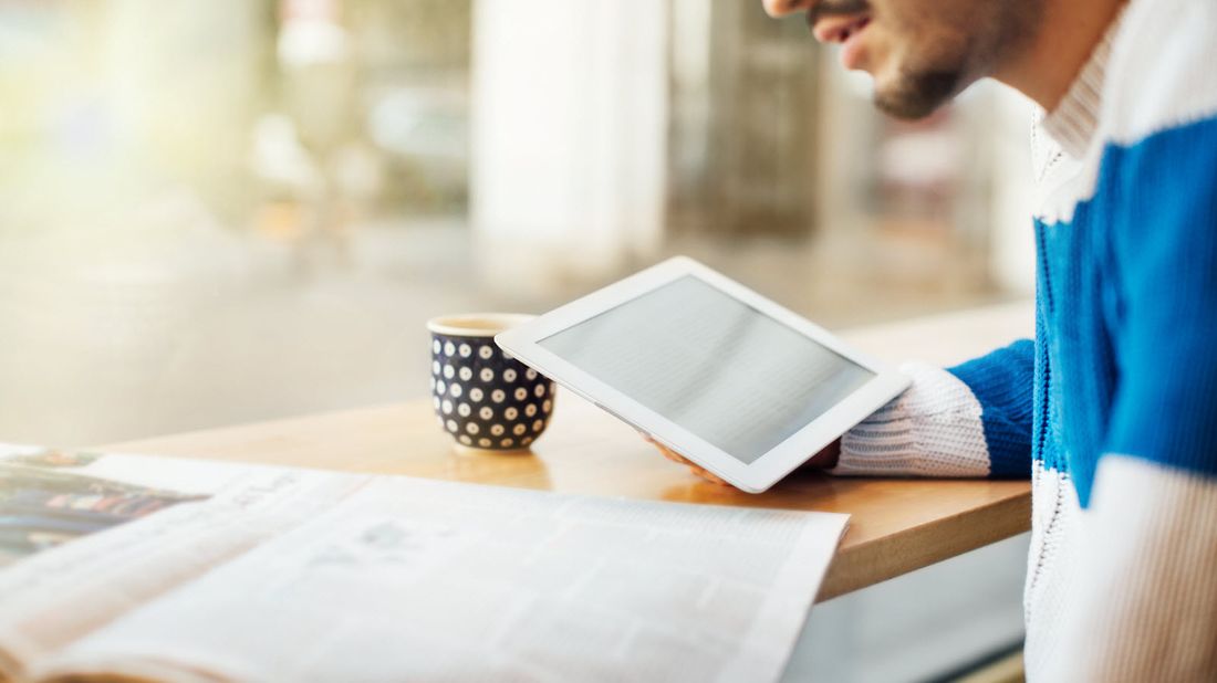 Man drinking coffee while reading Northwestern Mutual Market Commentary for May 24, 2021