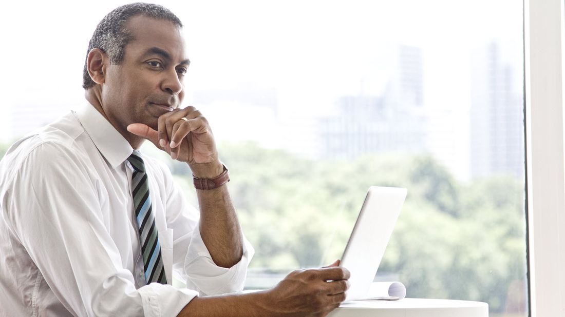 Businessman at a computer reading Northwestern Mutual Market Commentary