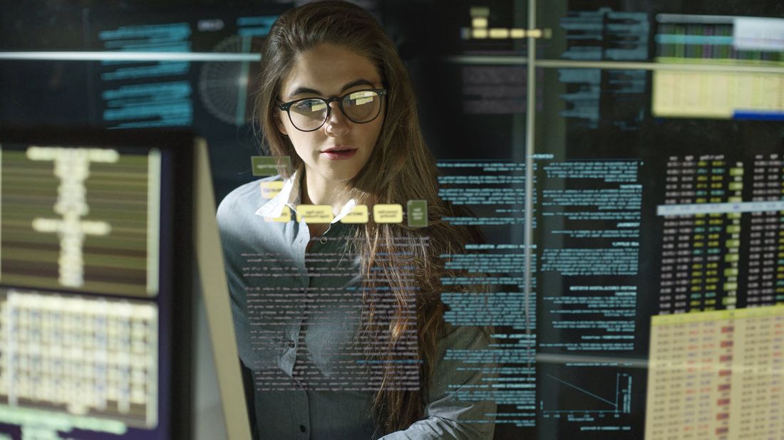 Woman looking at computer screens.