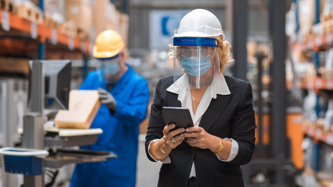 A warehouse manager checks inventory