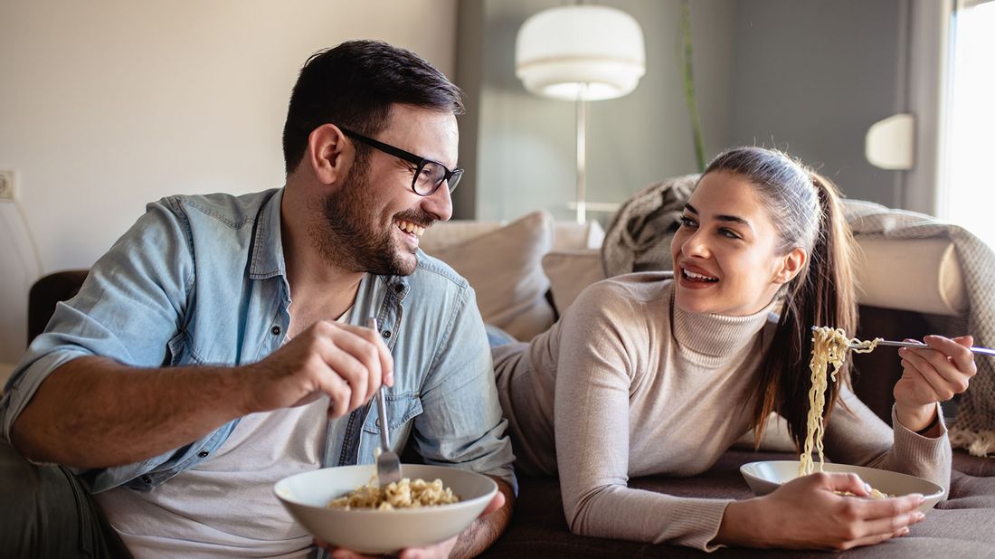 man and woman enjoying a takeout meal