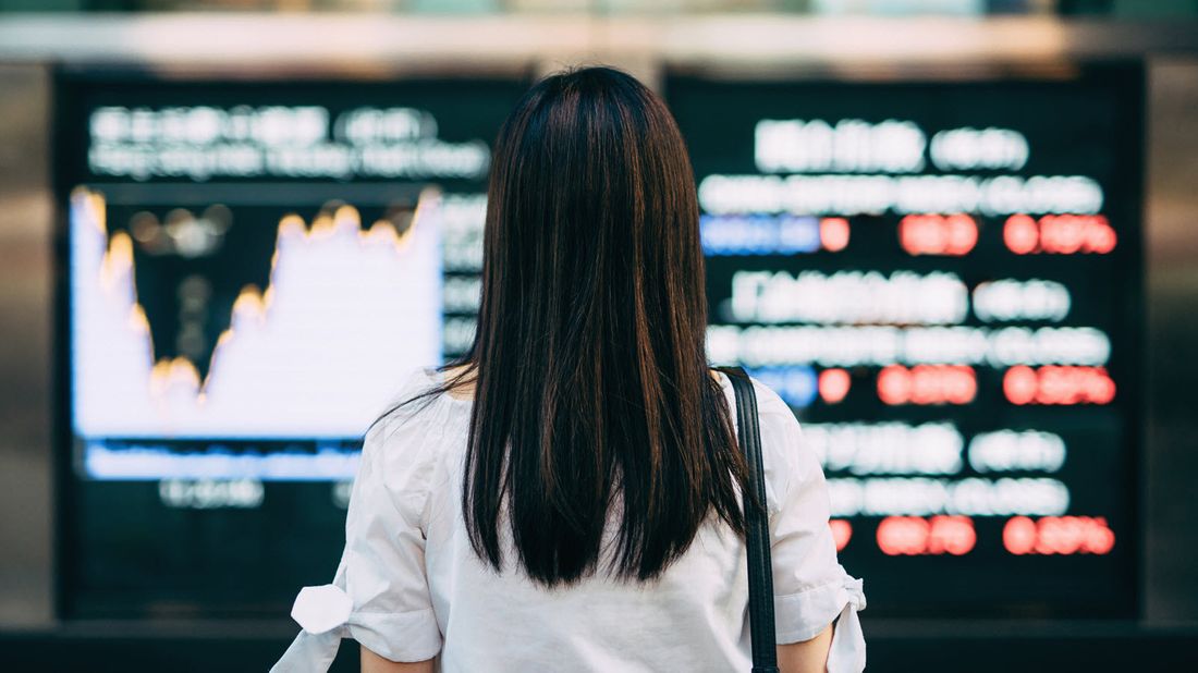 A woman looking at stock prices 