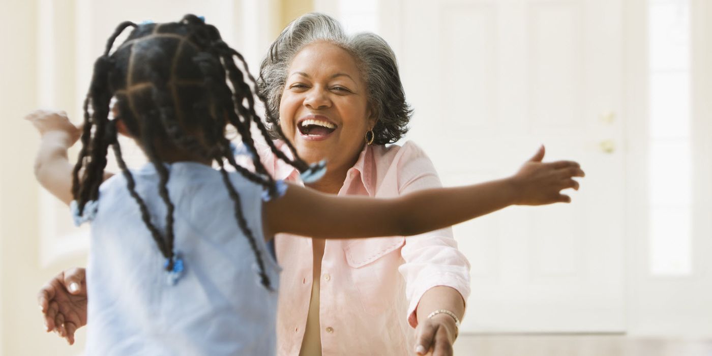 Granddaughter running to her grandma for a hug.