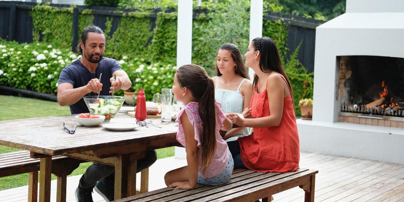 family enjoying summer lunch on outdoor patio