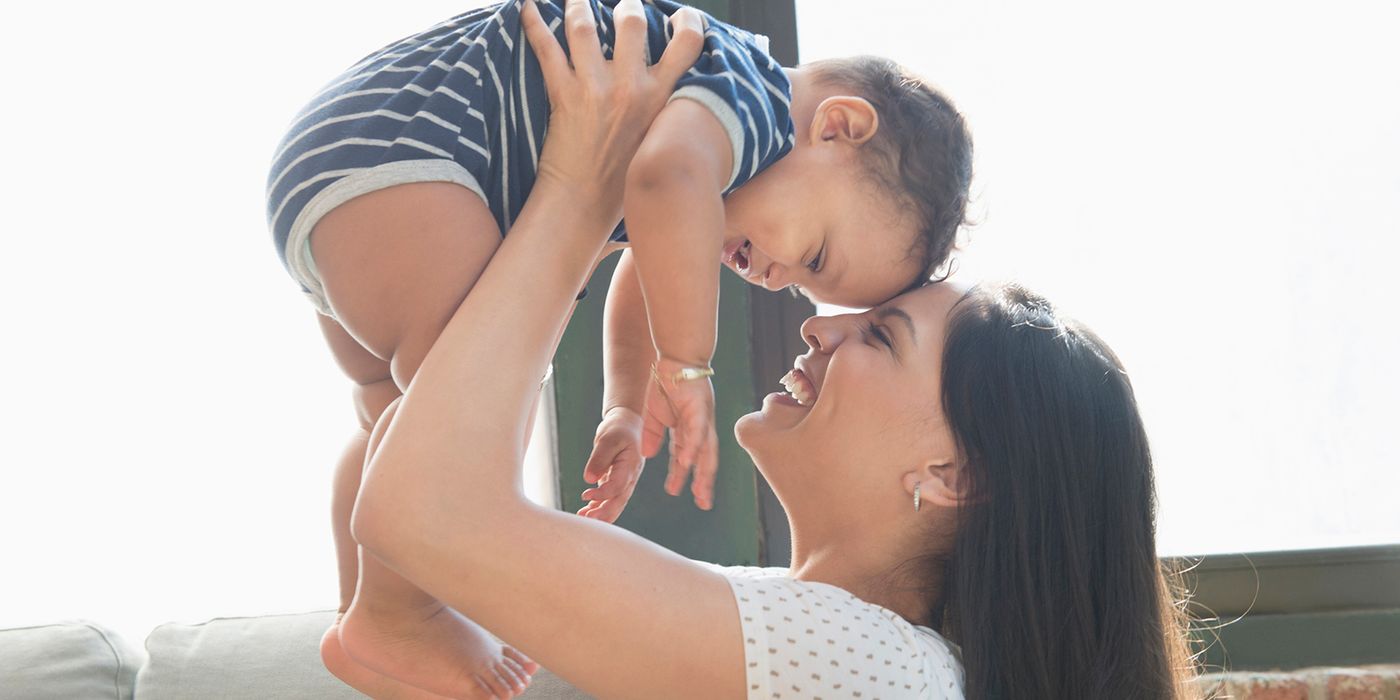 smiling mother holding baby
