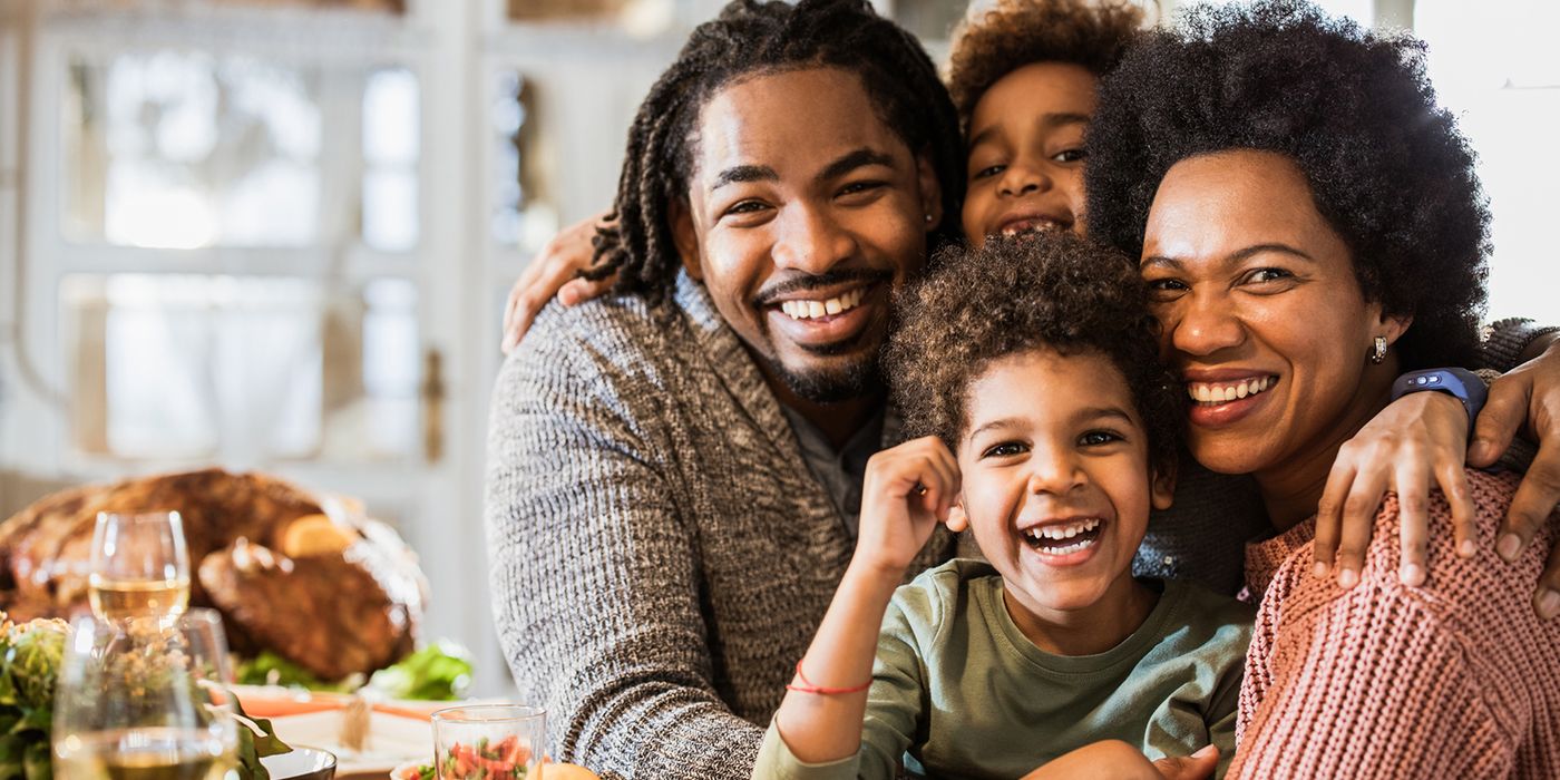smiling family enjoying Thanksgiving dinner