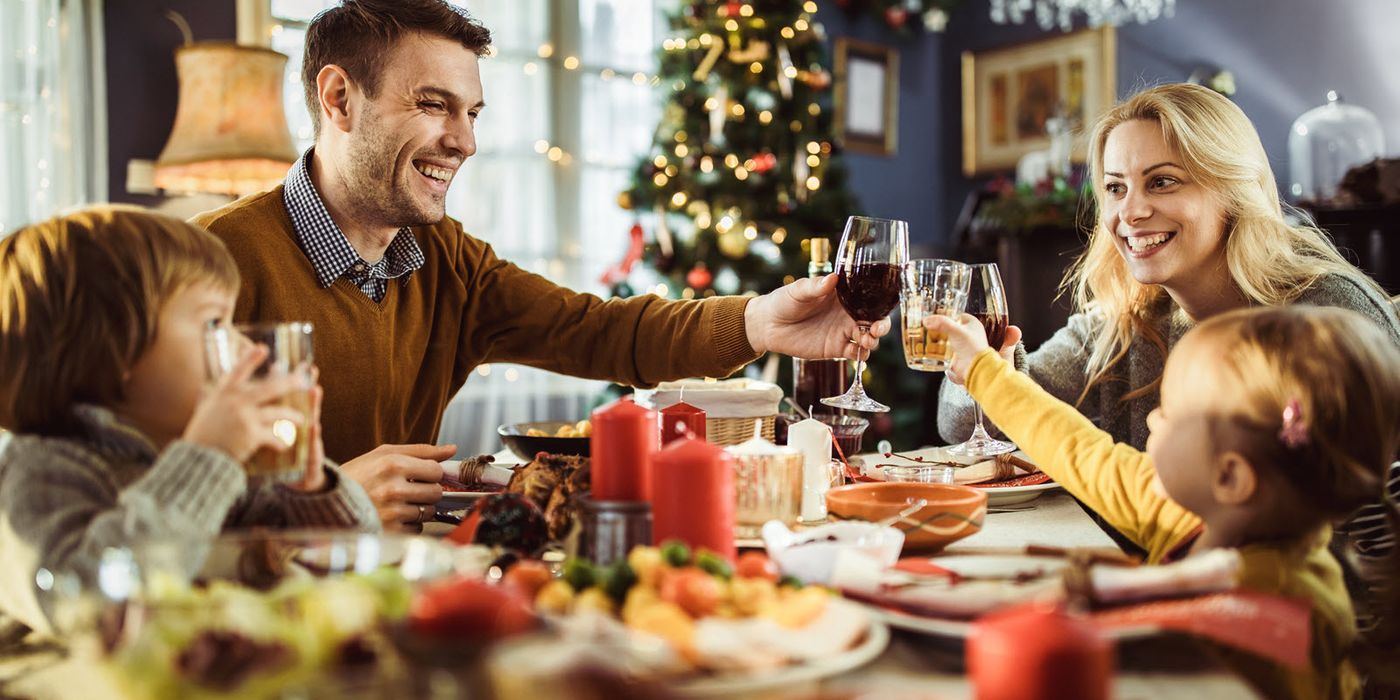 Family toasting each other at a dinner table