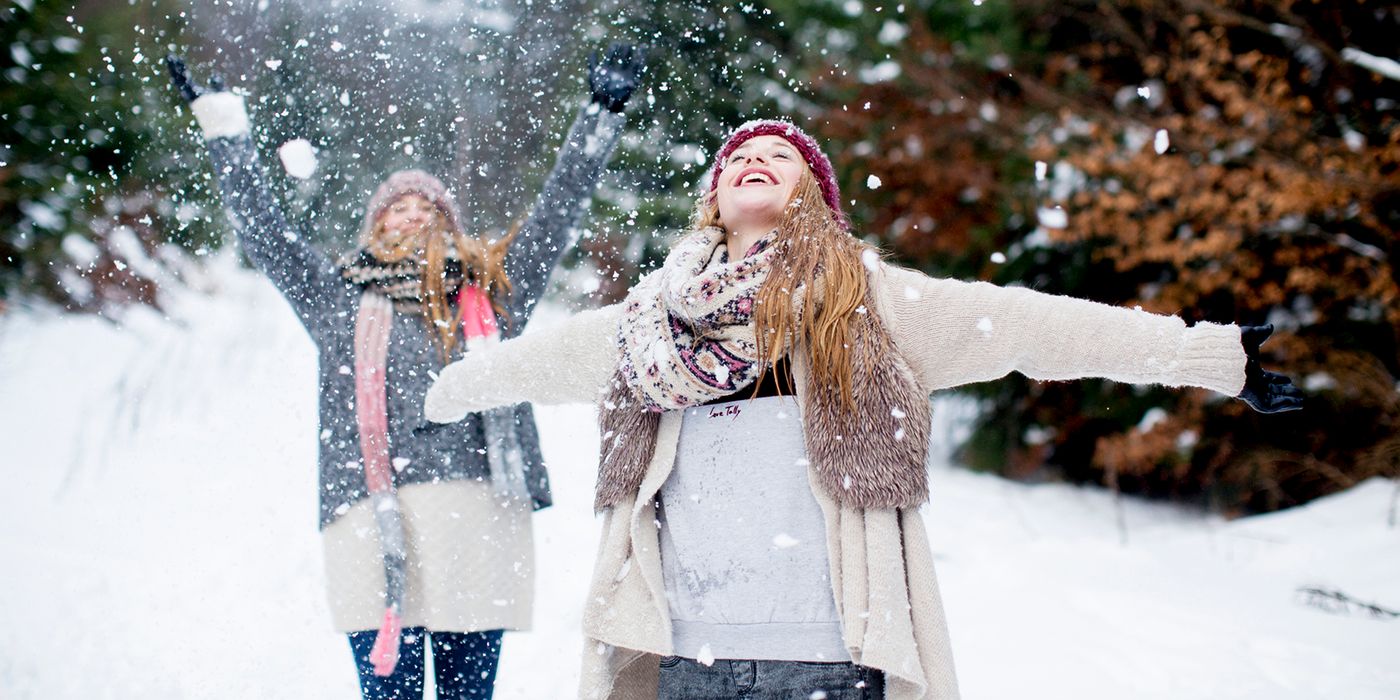 two women enjoying the snow