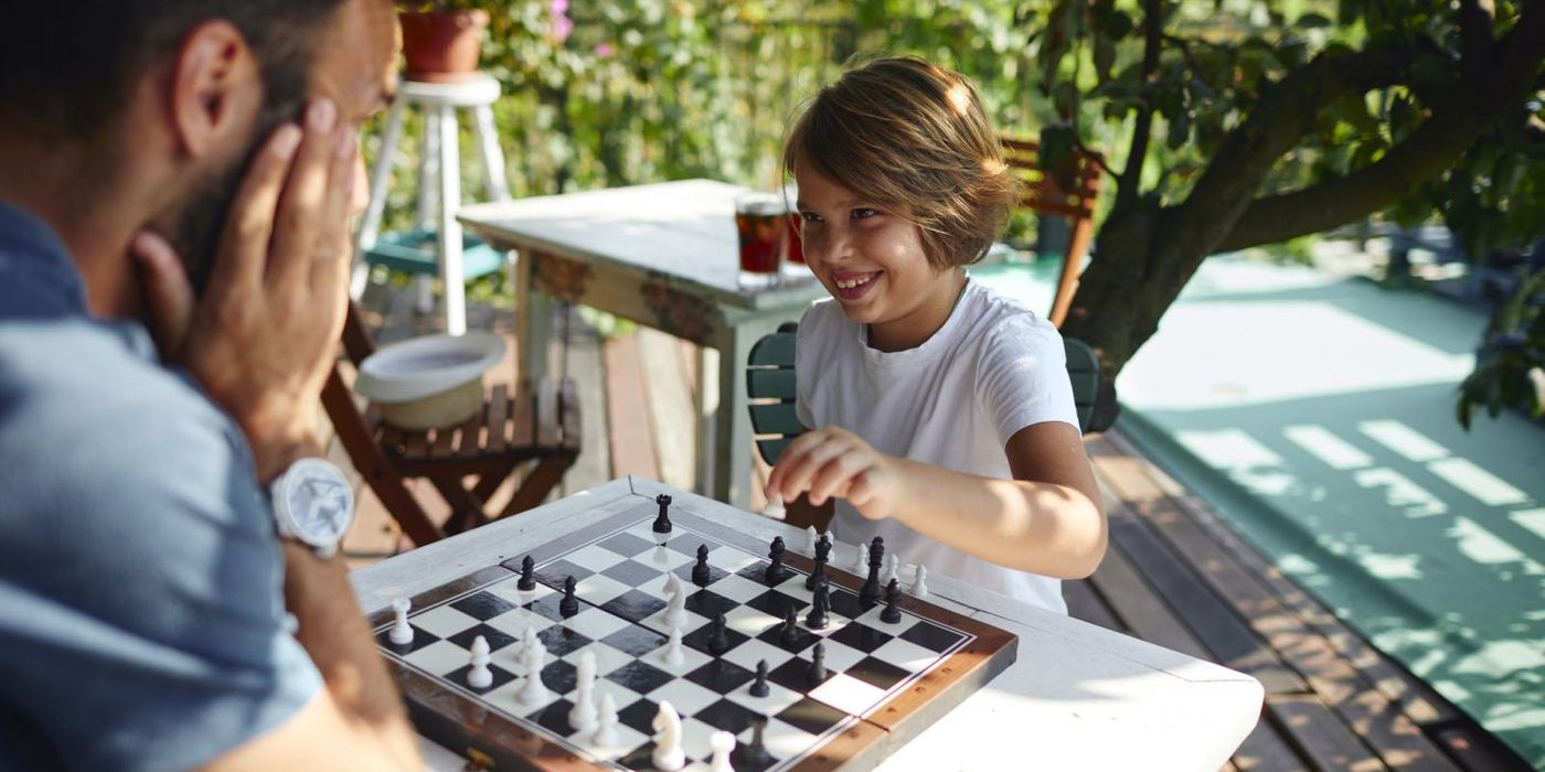 April Buy Skip Father and Son Playing Chess Together