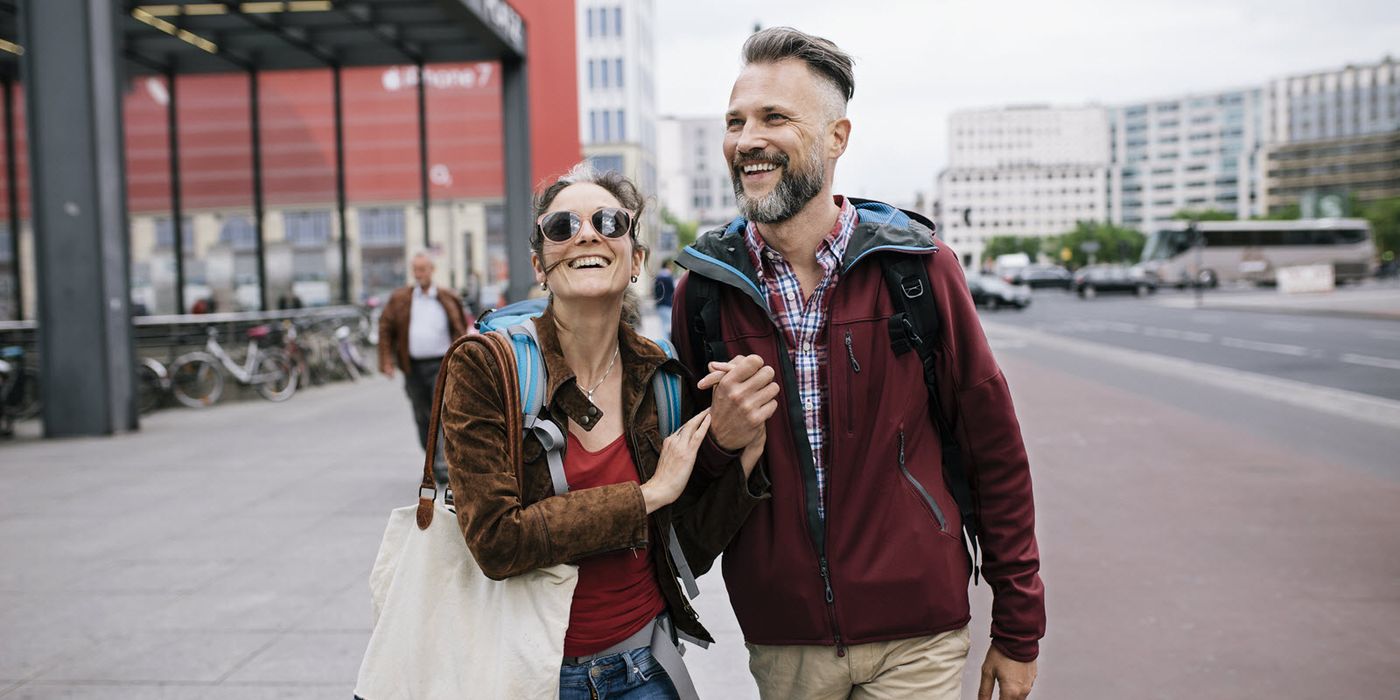 Couple walking along a street discussing holistic wealth management
