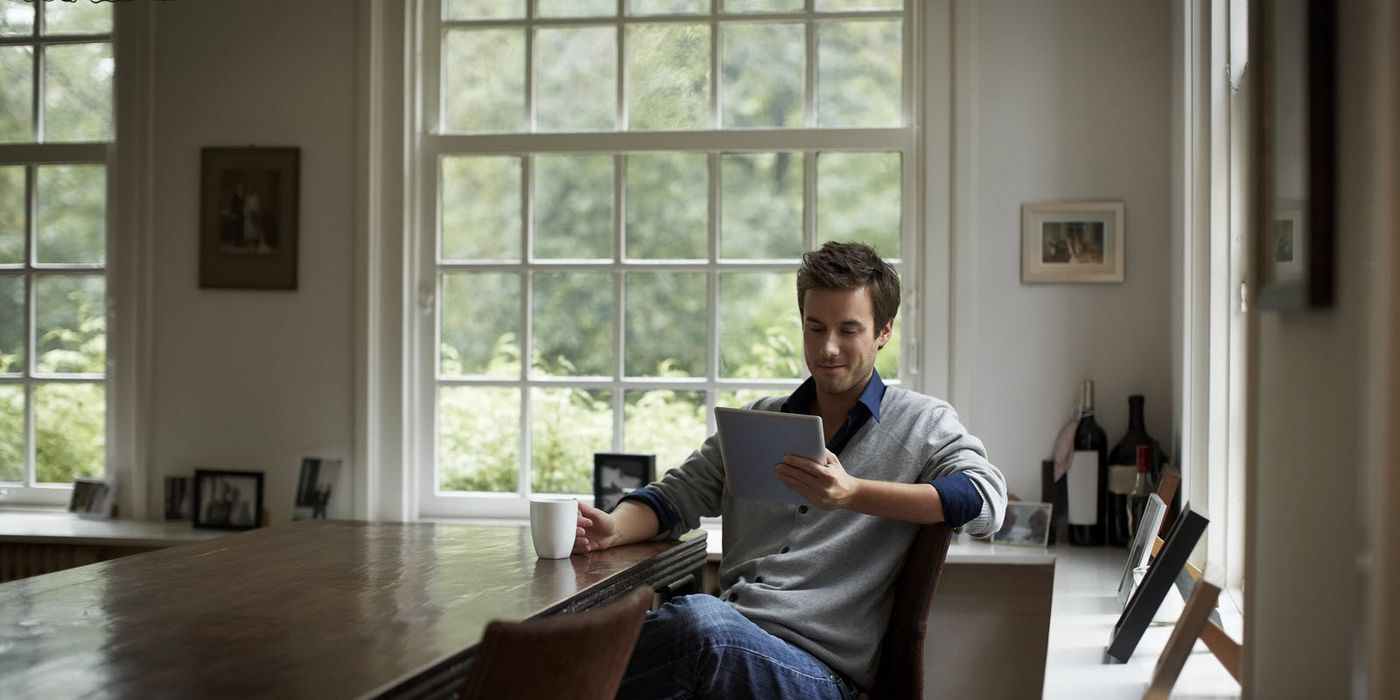 Man sitting at a table and reading Northwestern Mutual Market Commentary