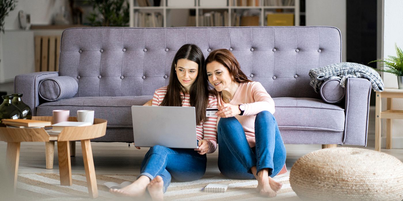 mother teaching daughter how to use credit cards responsibly
