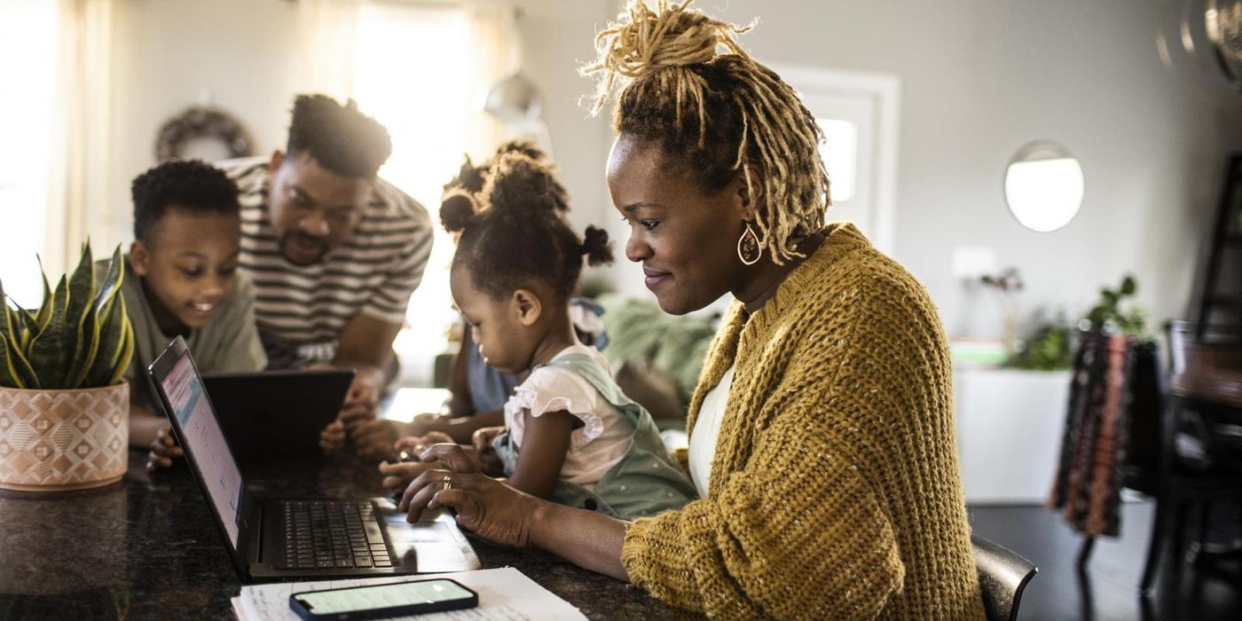Mom with family in kitchen doing financial planning for families