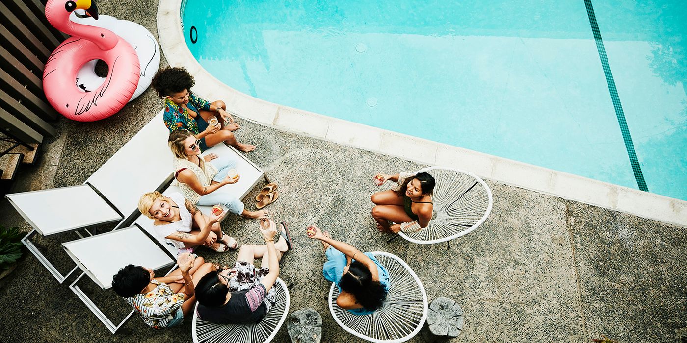 friends and family at a pool party in the backyard