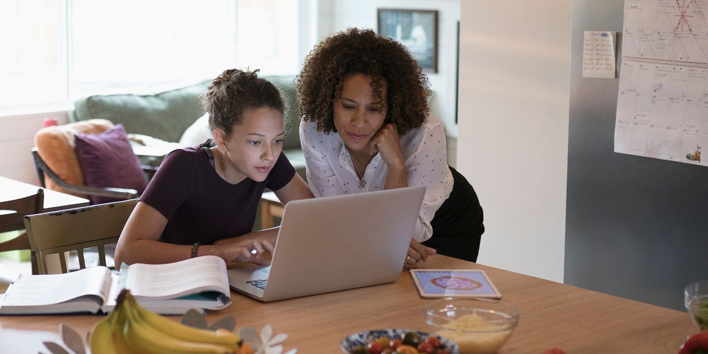 mom and daughter working on FAFSA in kitchen