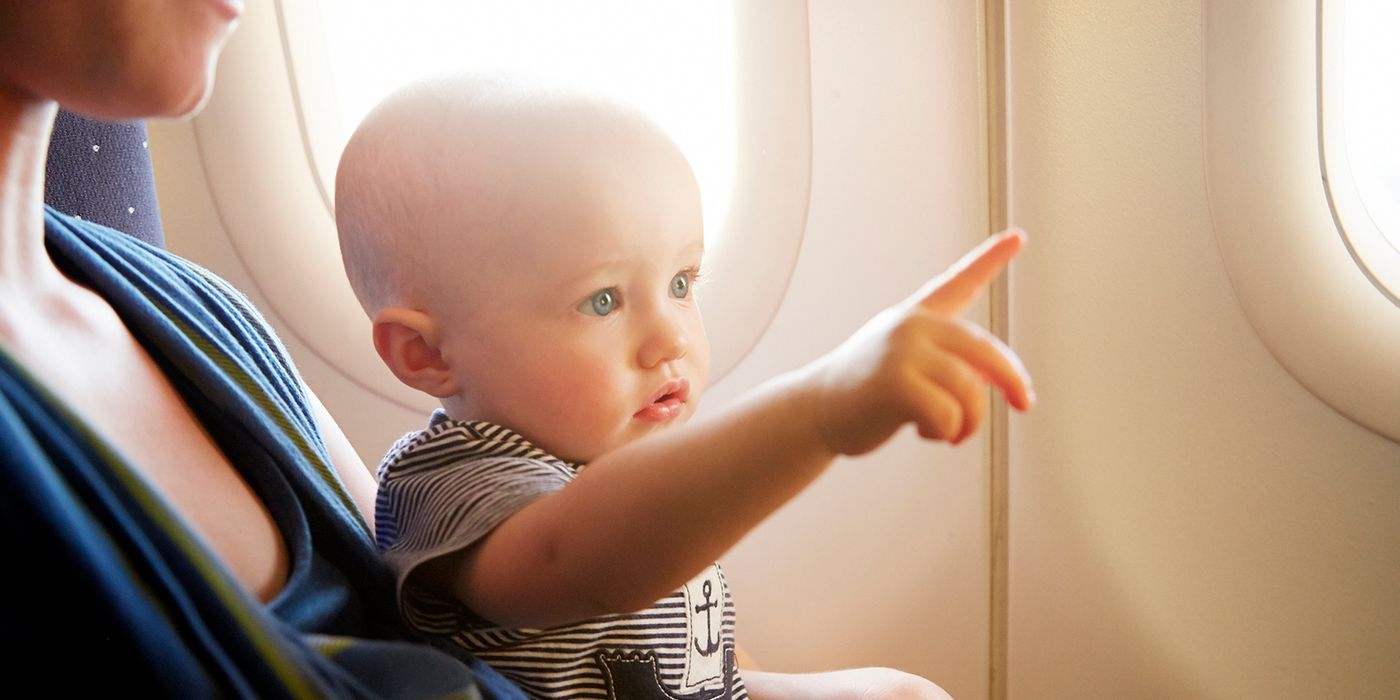 baby on plane pointing