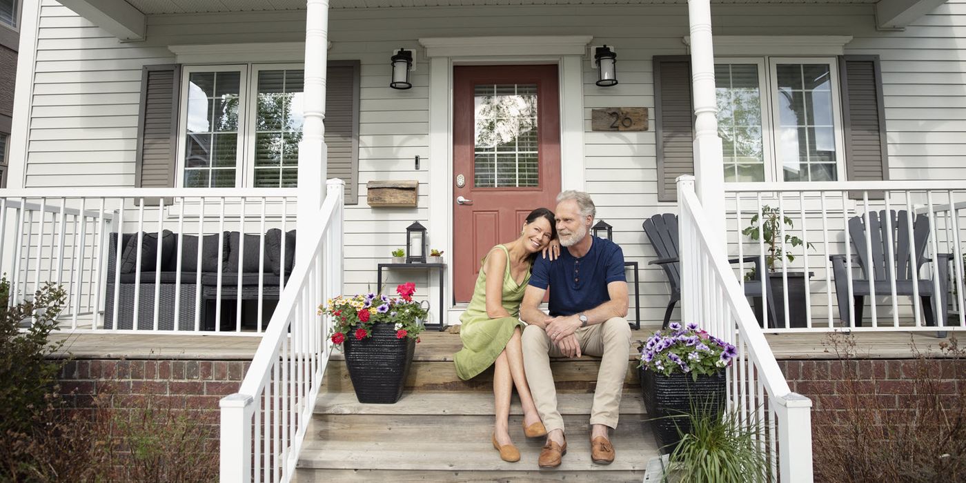 Couple sitting on front porch steps.