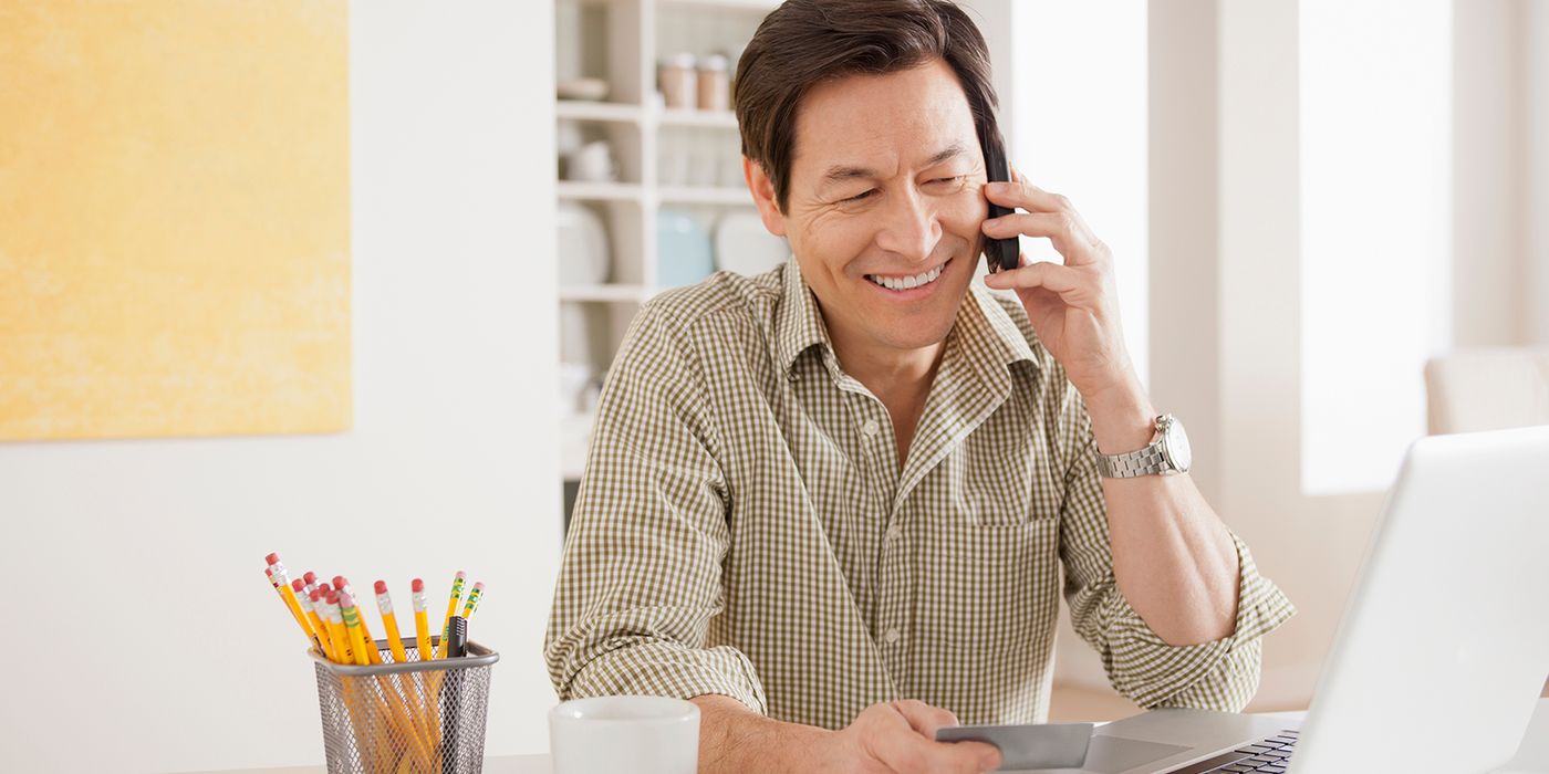 man negotiating credit card interest rate over the phone