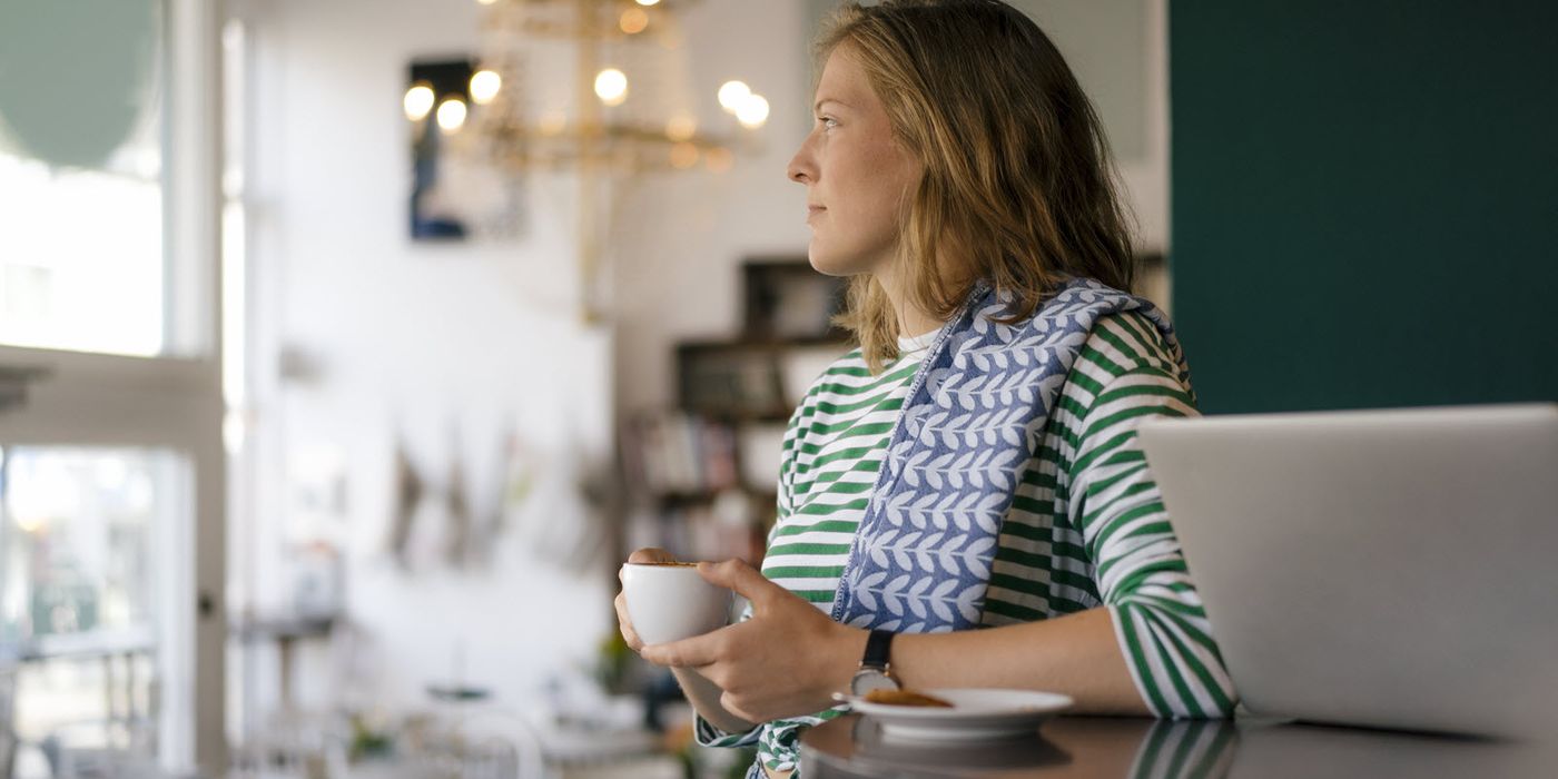 Woman in a coffee shop considering whether a Roth conversion makes sense.
