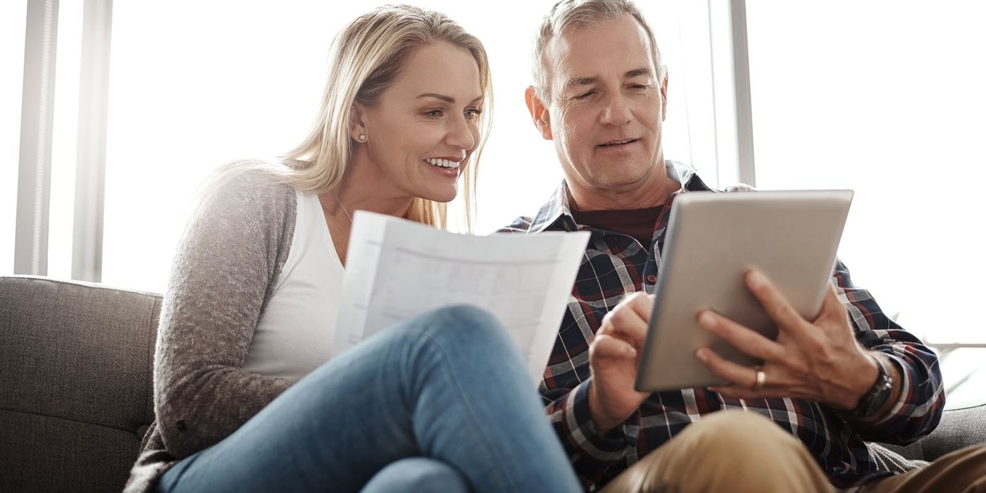Couple looking at a tablet researching whether an annuity is an investment or an insurance policy.