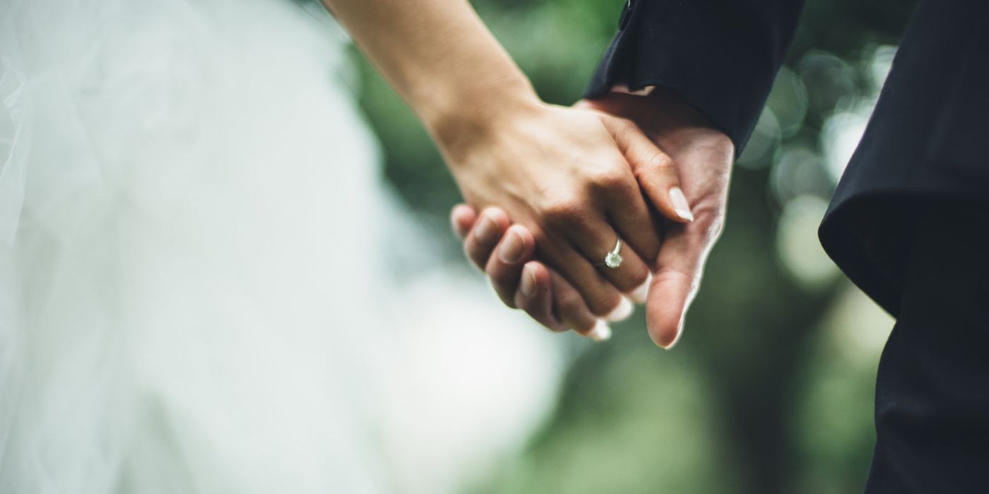 A newly married couple holding hands