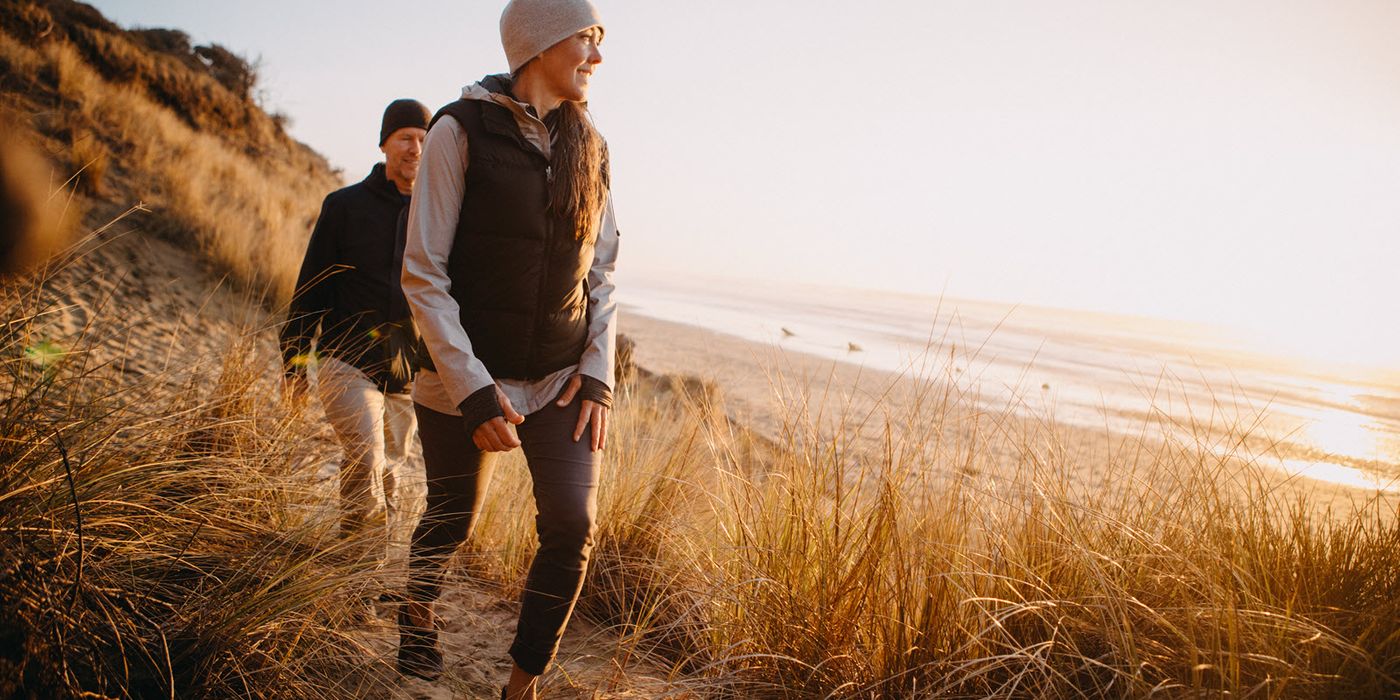Couple hiking near the beach thinking about how much an average retirement costs.