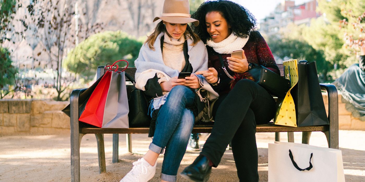 Friends after shopping looking at how holiday budget is blown