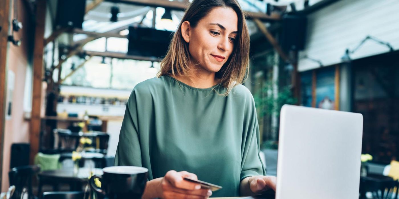 Woman using credit card and laptop