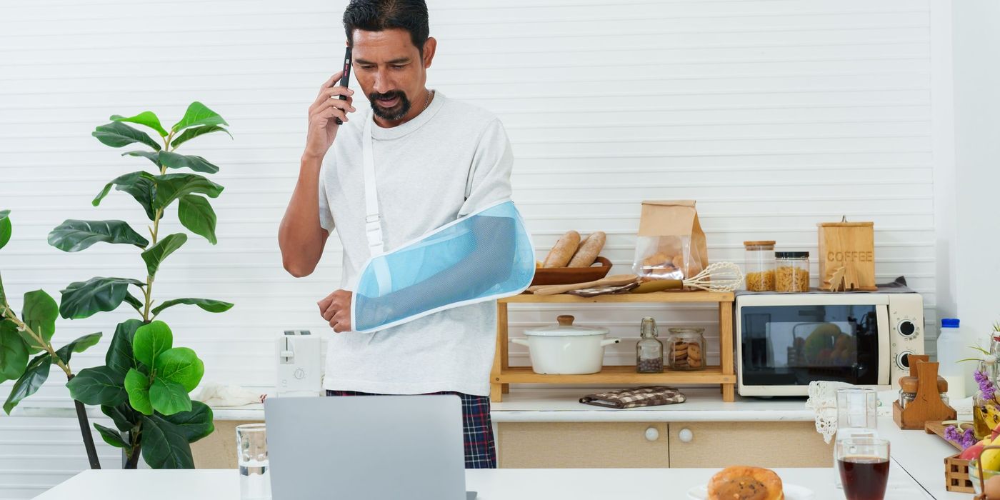 Man at home with injured arm