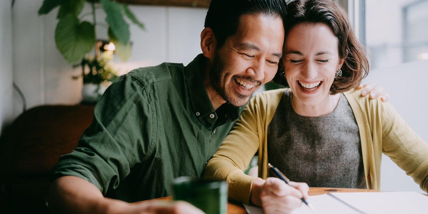Happy couple combining finances after marriage