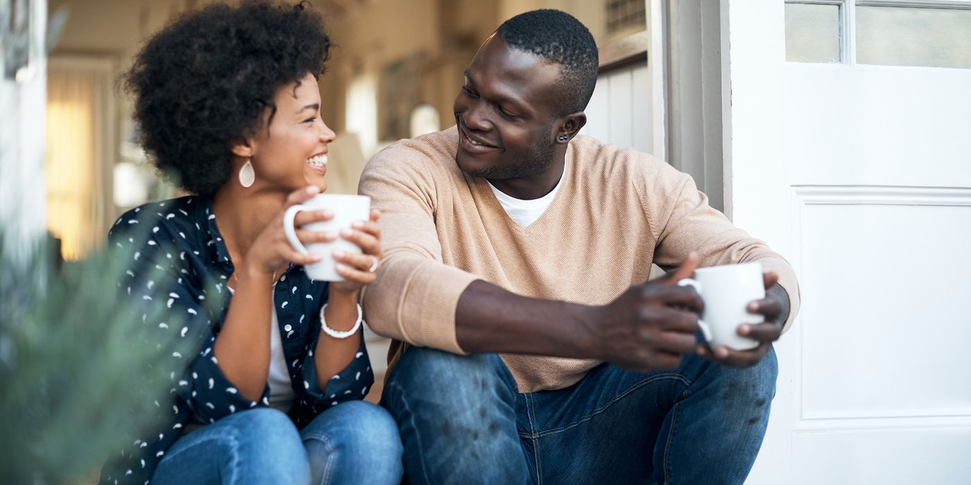 Newlywed couple having coffee and talking about money