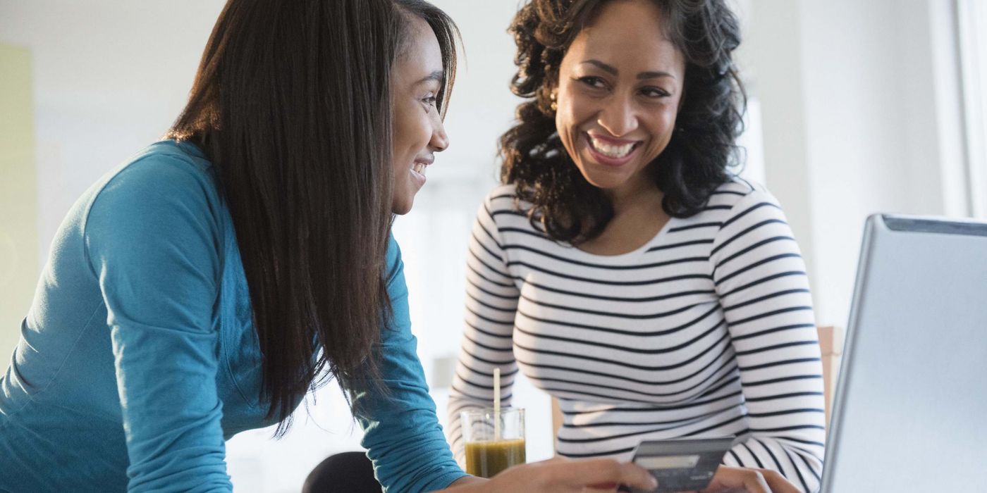 Mother teaching daughter about credit