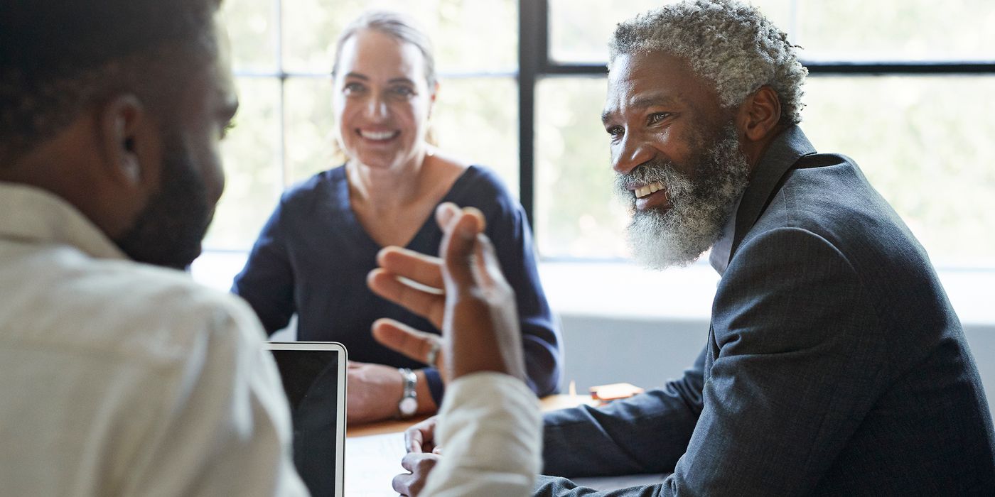 Man who has unretired in a business meeting with colleagues