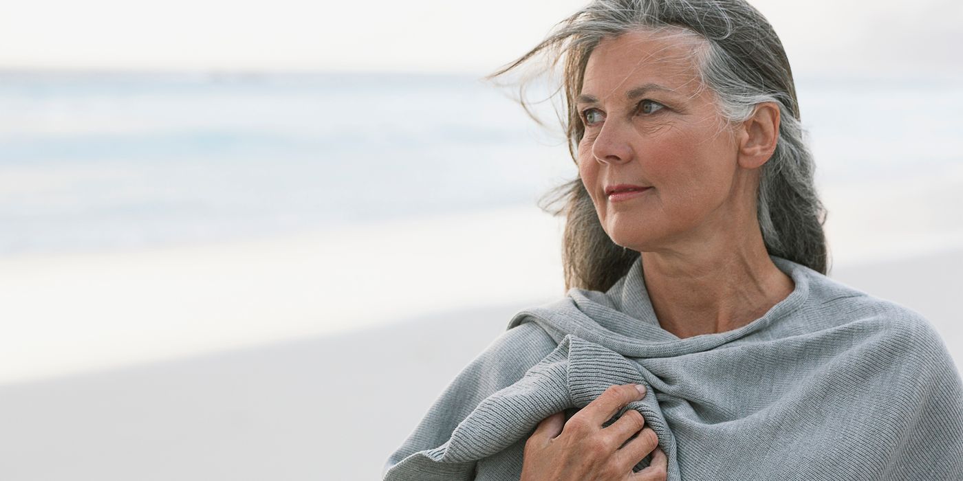 woman on beach considering divorce before retirement