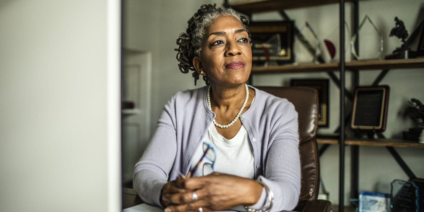 Woman contemplating the role of a trustee and whether she should select an individual or corporate trustee as a part of her estate plan.
