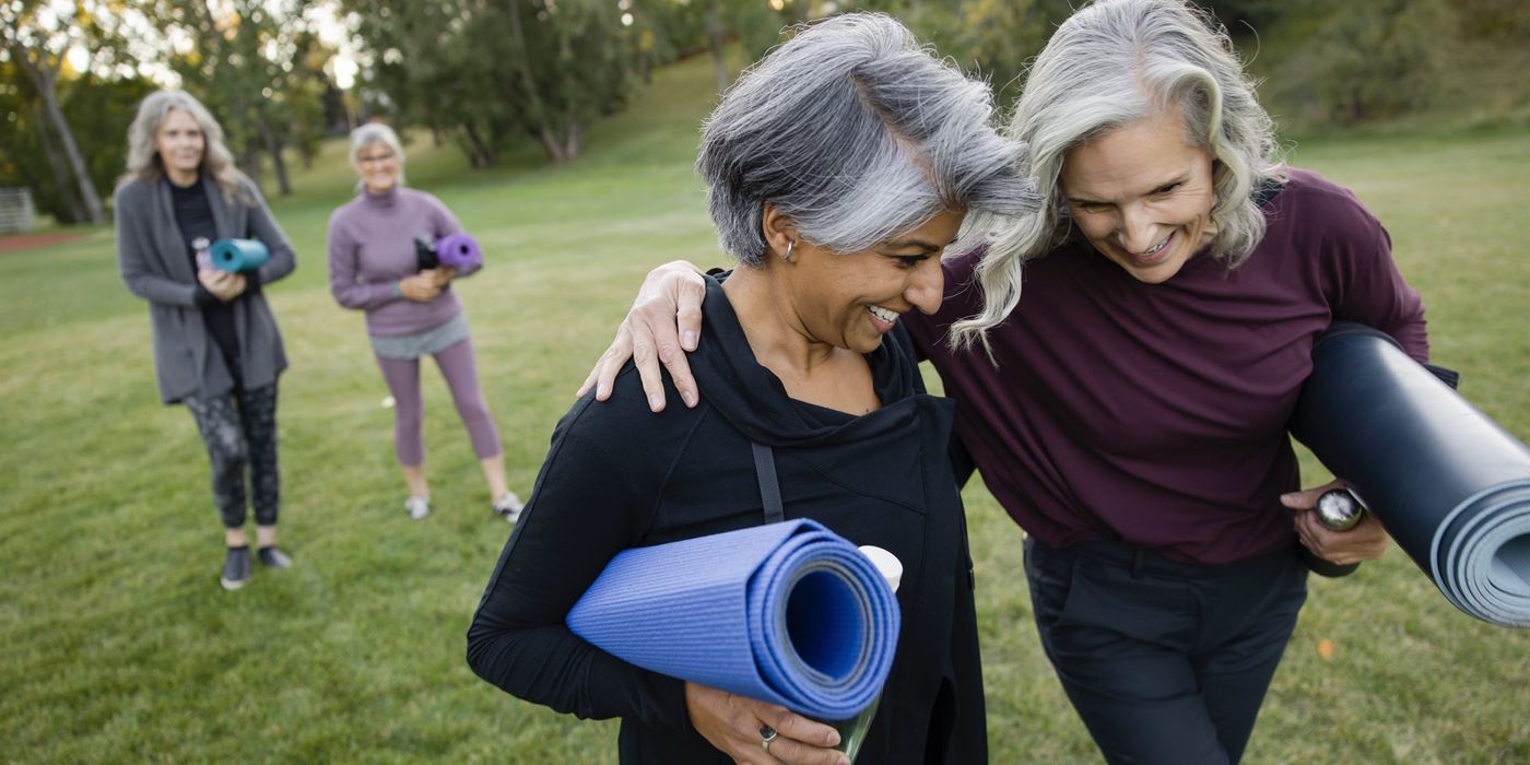 retired women walking with yoga mats
