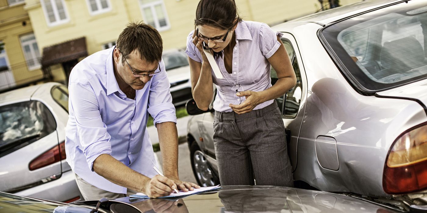 two people with liability insurance fill out paperwork