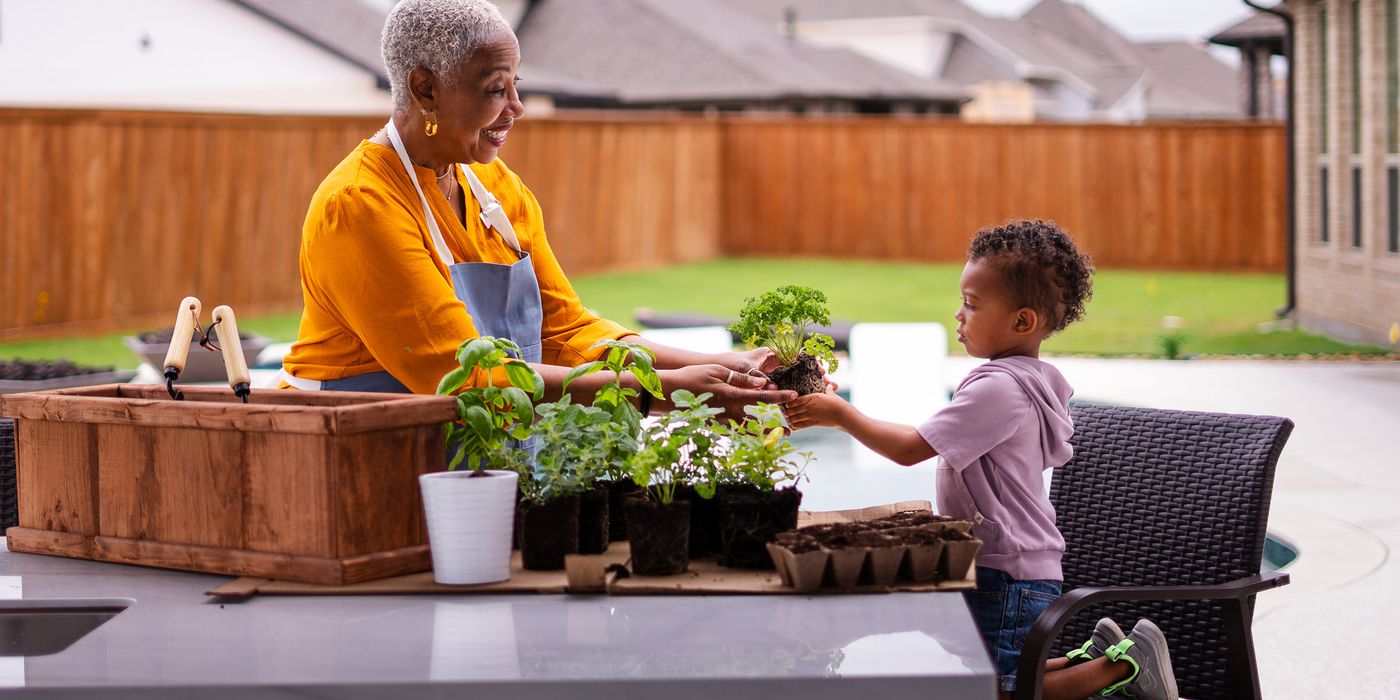 Grandmother gardening with her grandson