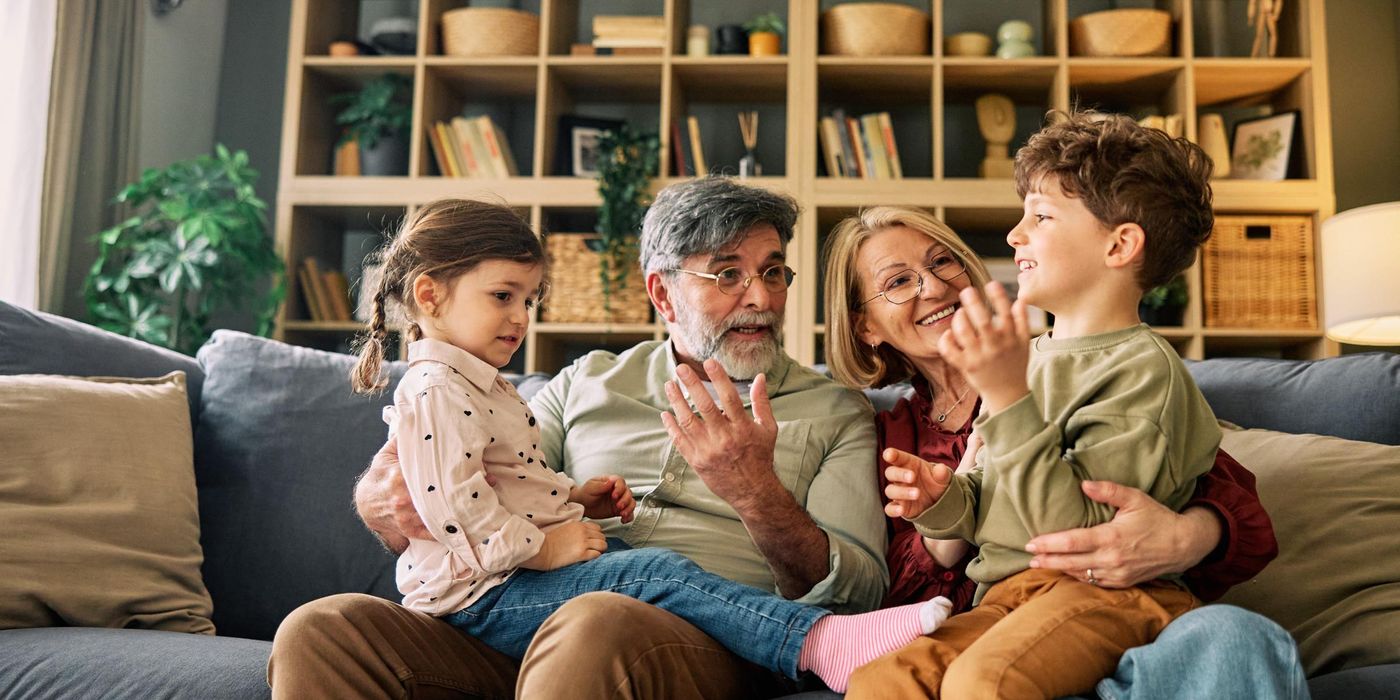 Grandparents talking with grandchildren on sofa