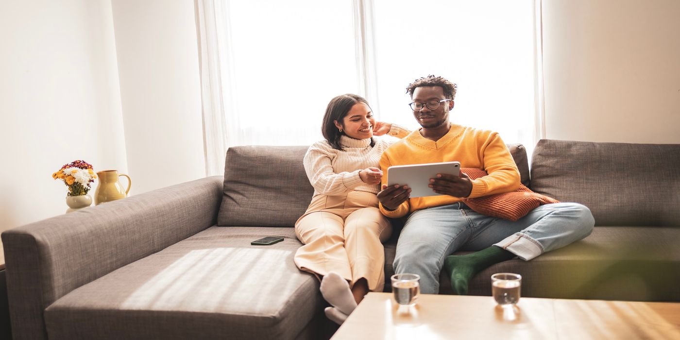 Couple relaxing on a sofa having a conversation