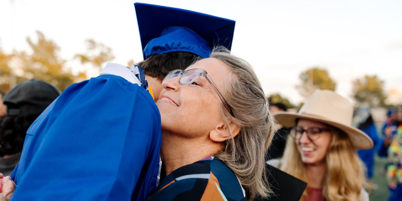 Grandmother hugs graduate 