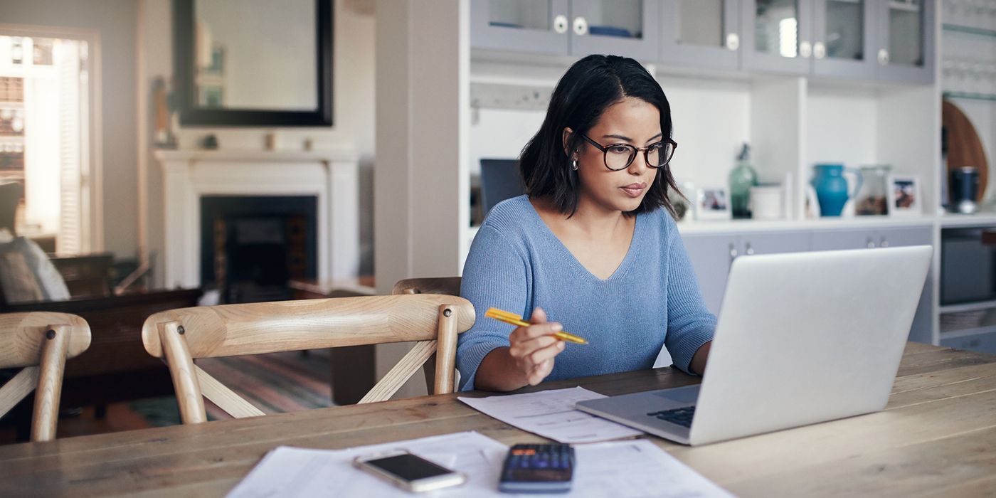Woman working on her finances on a laptop.