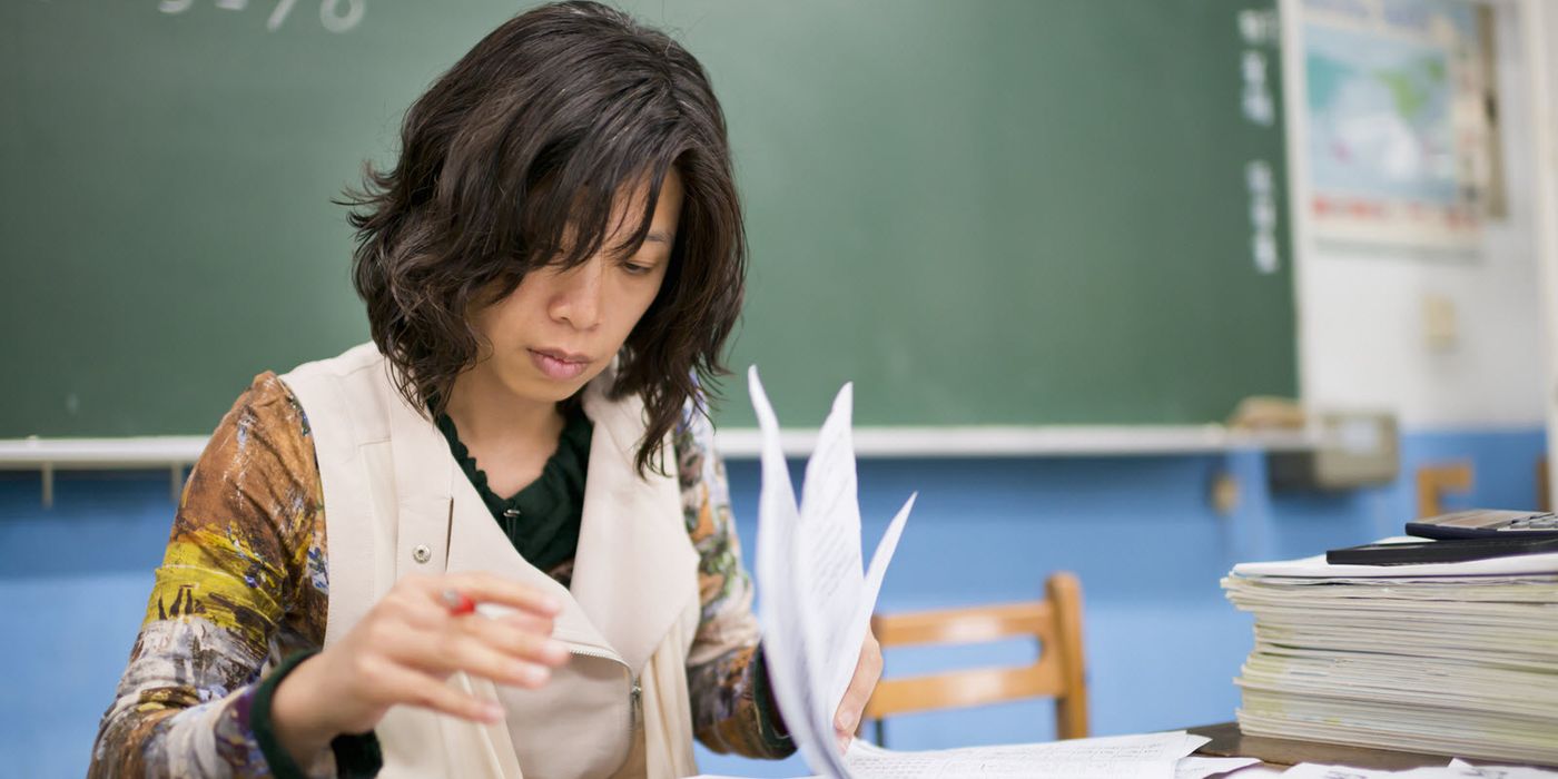 A school teacher grading papers at her desk